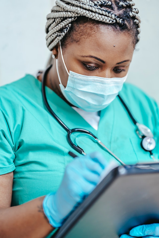 nurse looking at the clipboard